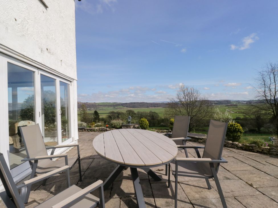 A patio area with a table and chairs at Barn Howe Lyth near Levens