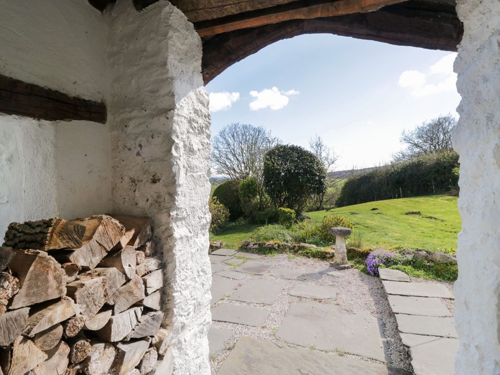A view of a garden with a stone path and shrubs at Barn Howe in Lyth near Levens