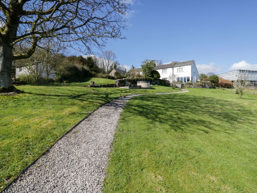 An outdoor area with a pathway and house at Barn Howe Lyth near Levens