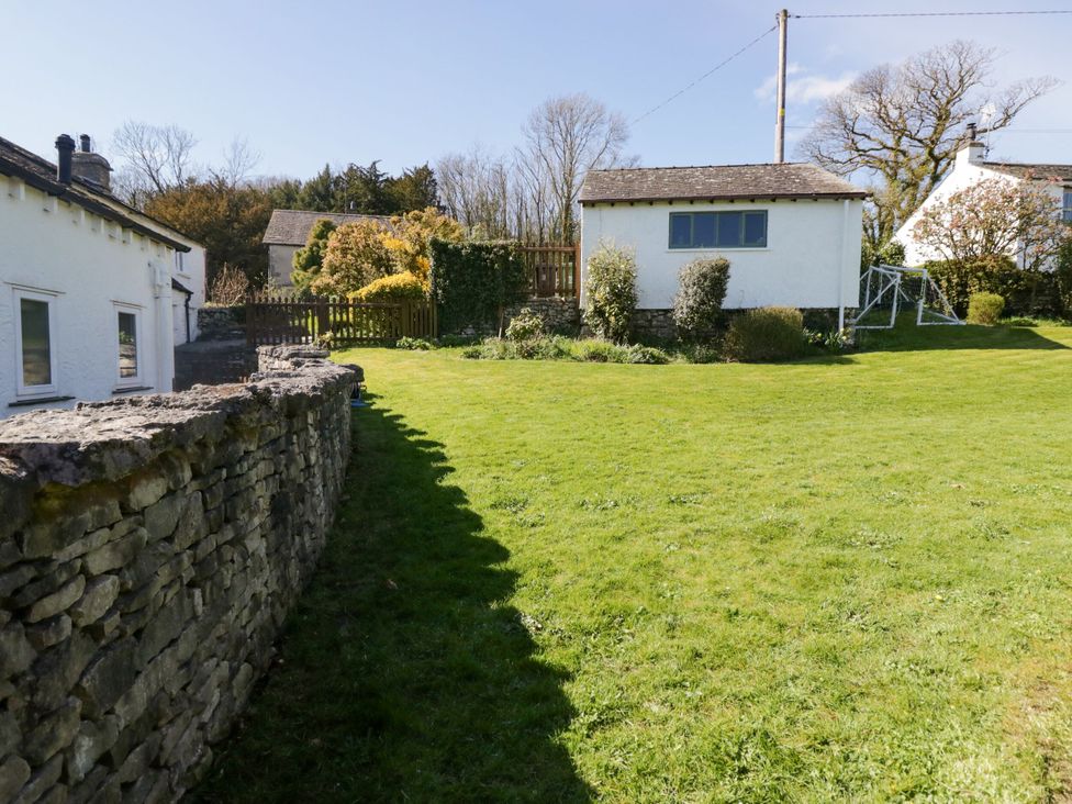 A garden with grass and a house at Barn Howe in Lyth near Levens