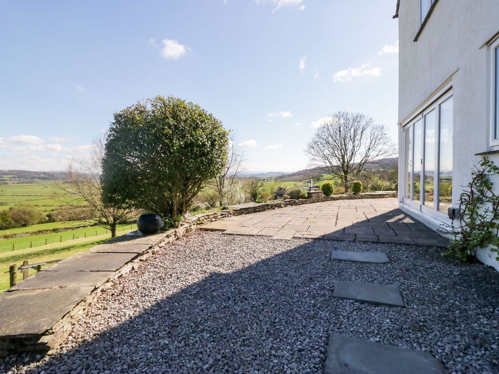 An outdoor area with stone slabs and gravel at Barn Howe Lyth near Levens