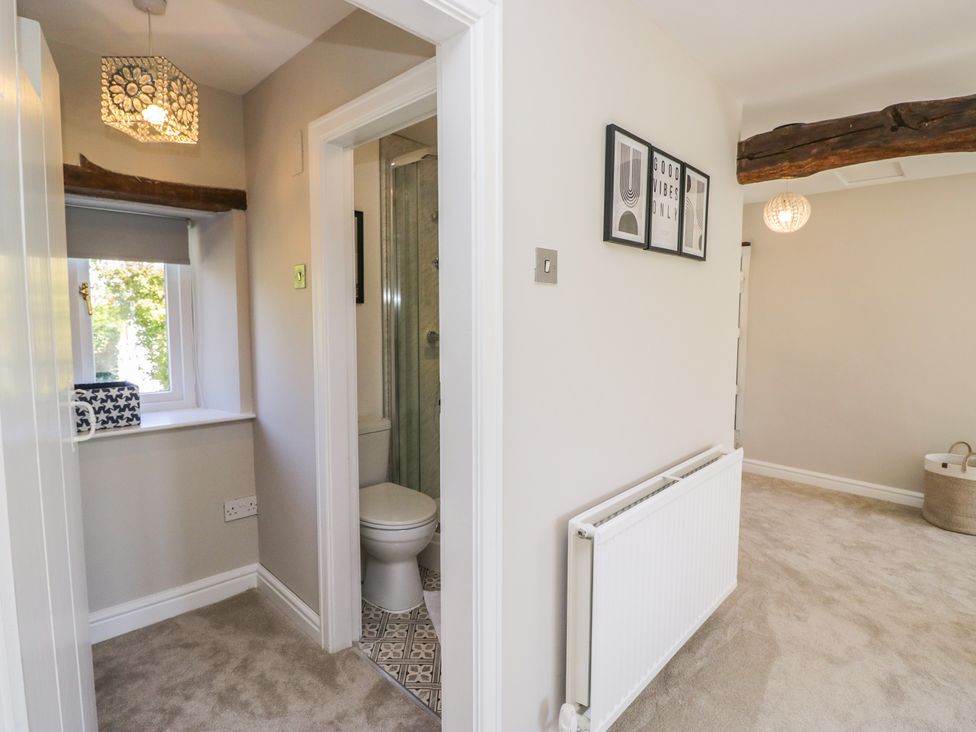 A bathroom with toilet and shower area at Barn Howe in Lyth near Levens