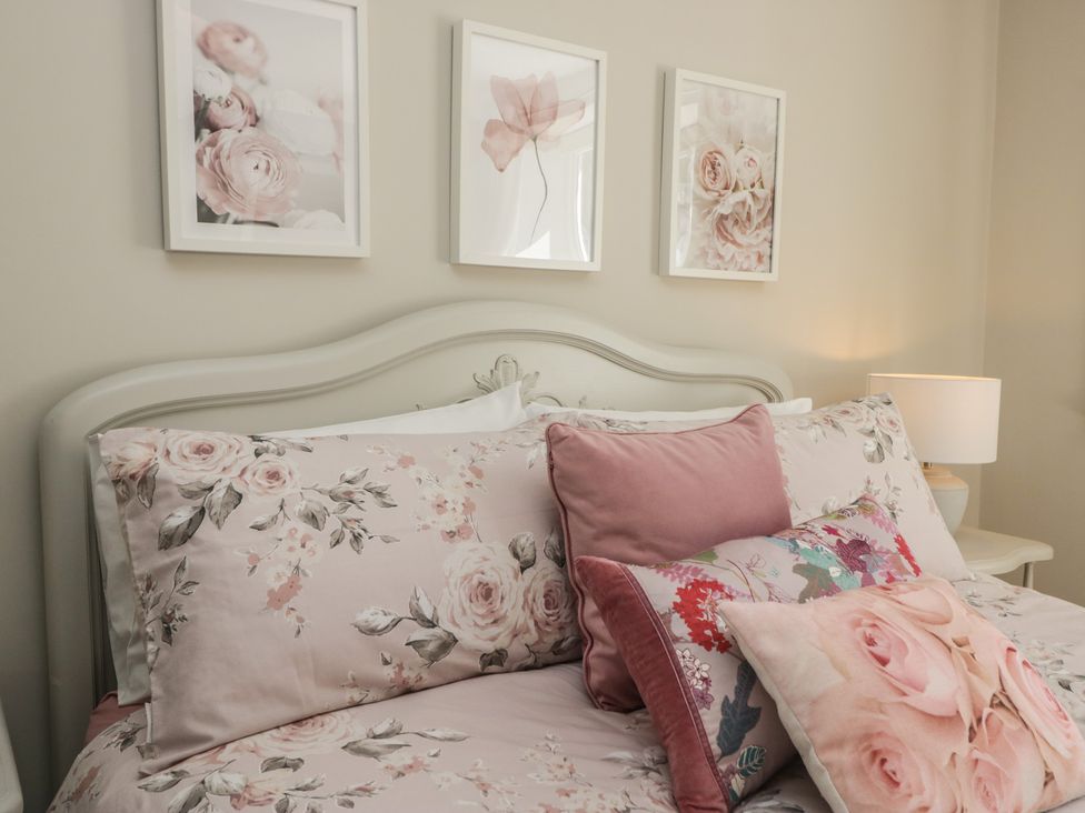 A bedroom with a bed and decorative pillows at Barn Howe in Lyth near Levens