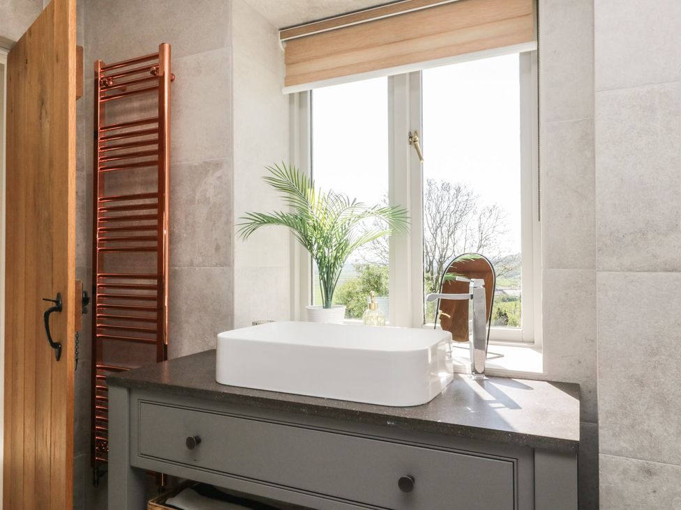 A bathroom with a sink and a towel radiator at Barn Howe Lyth near Levens