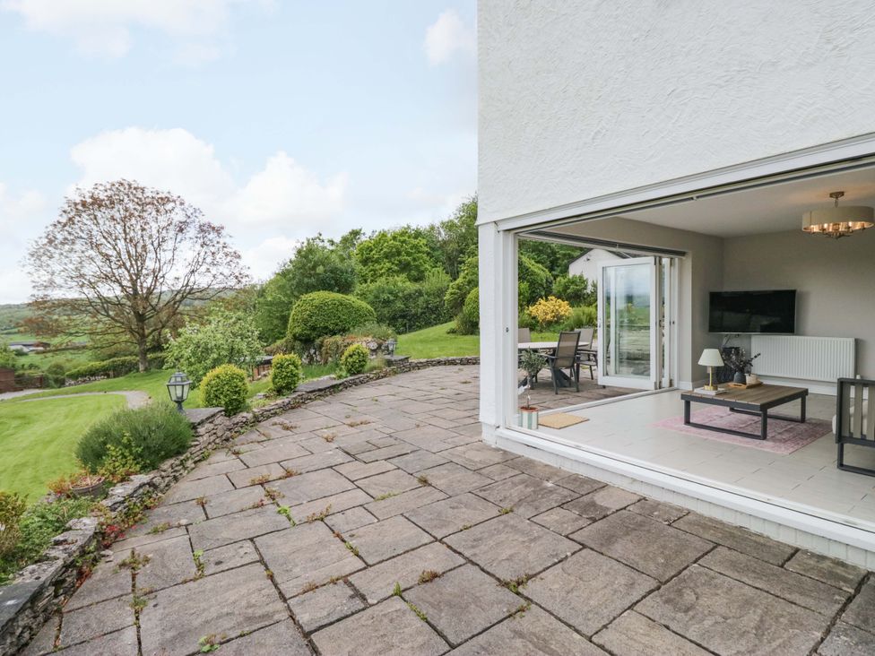 An outdoor patio area with furniture and a view at Barn Howe Lyth near Levens