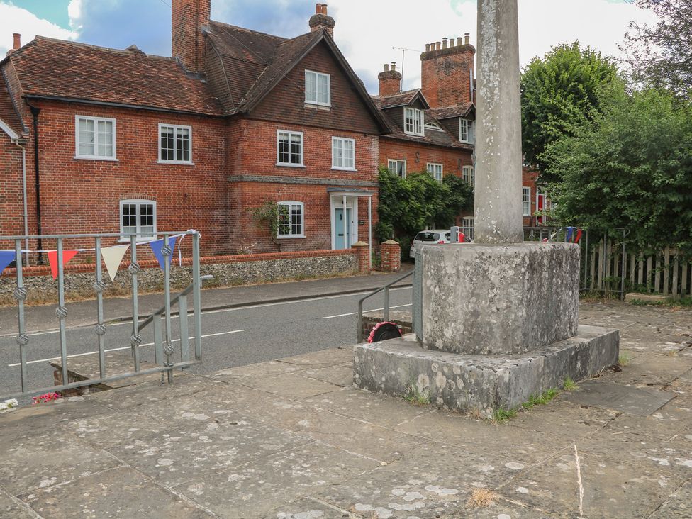 A residential area with houses and bunting outside Flat 1 in Winchester