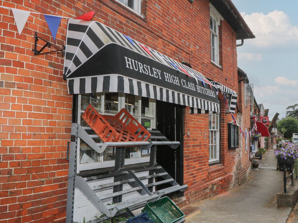 A butcher shop exterior with banners in Hursley at Flat 1 Winchester