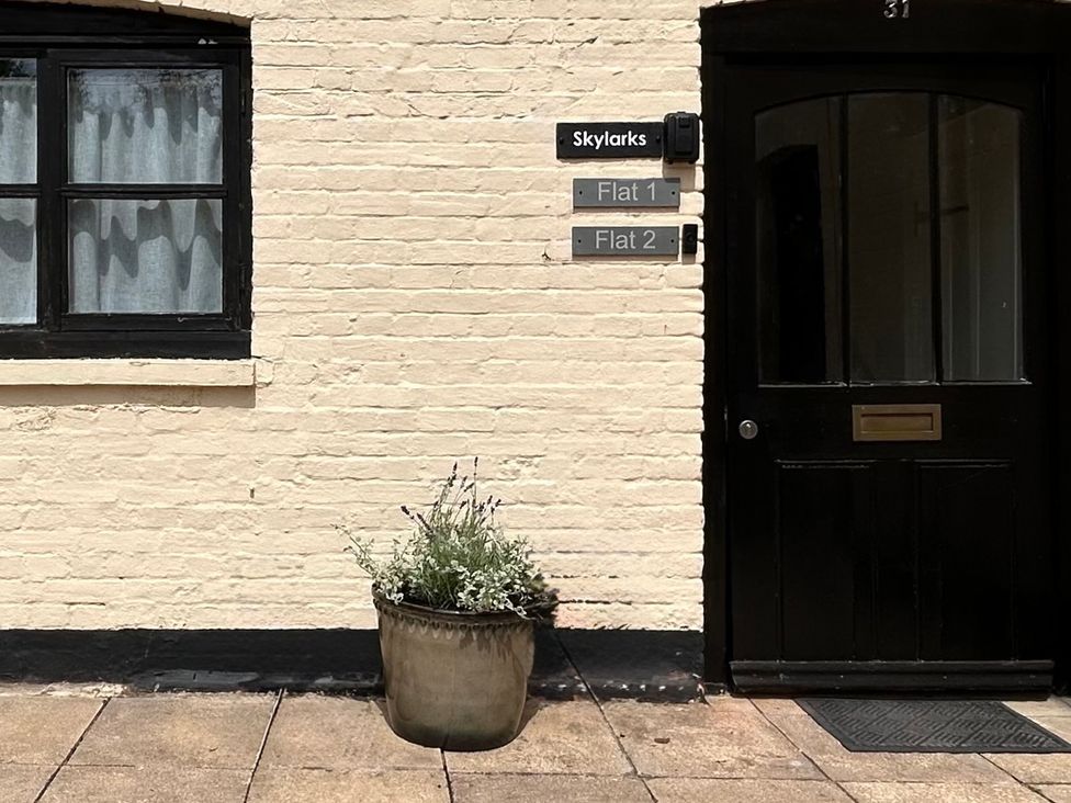 An entrance with a window and door labeled Skylarks in Winchester
