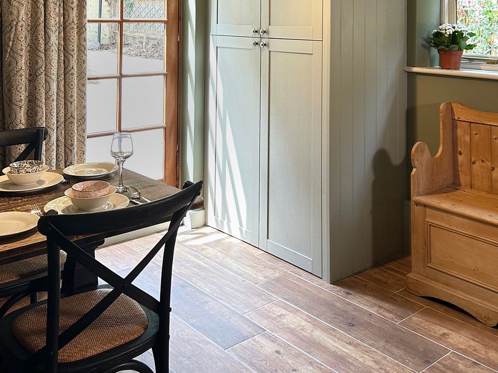 A dining room with a table set for meals at Skylarks in Winchester