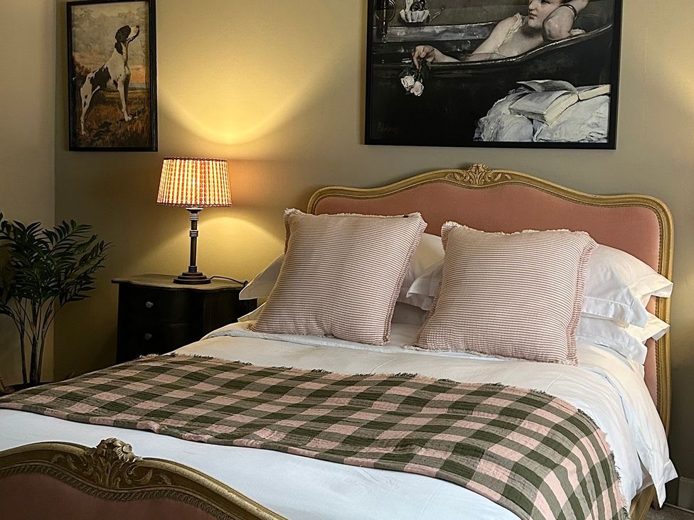 A bedroom with a bed and artworks at Skylarks in Winchester