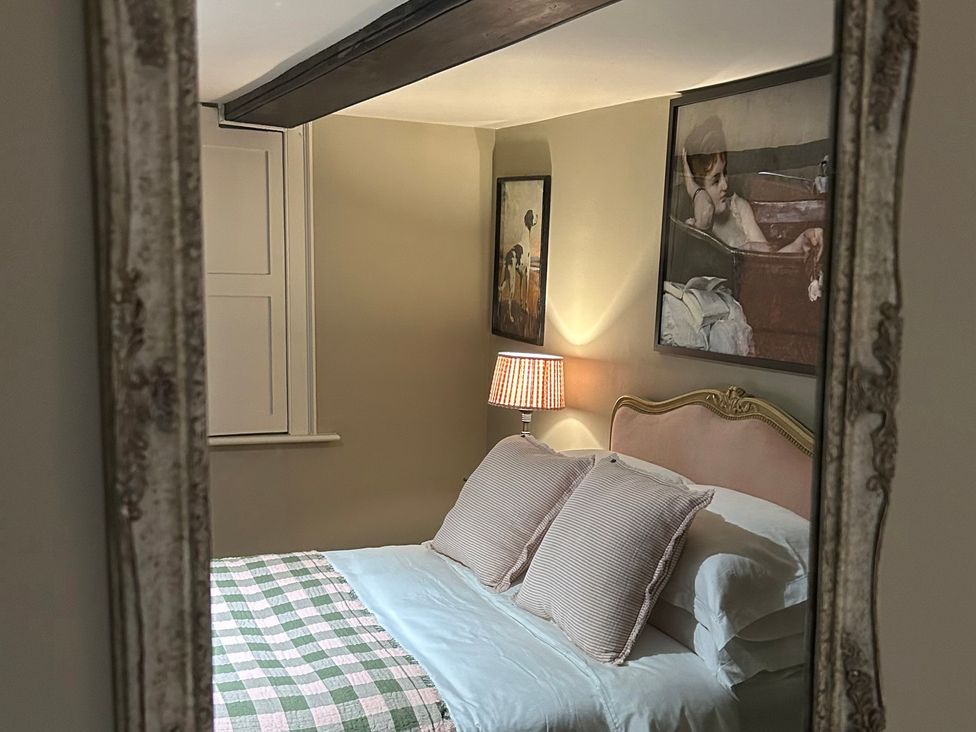 A bedroom with a bed and wall art at Skylarks in Winchester