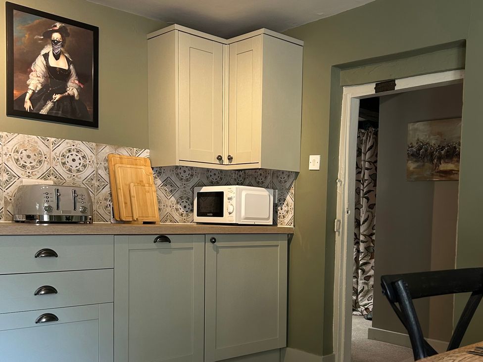 A kitchen with appliances and a painting at Skylarks in Winchester