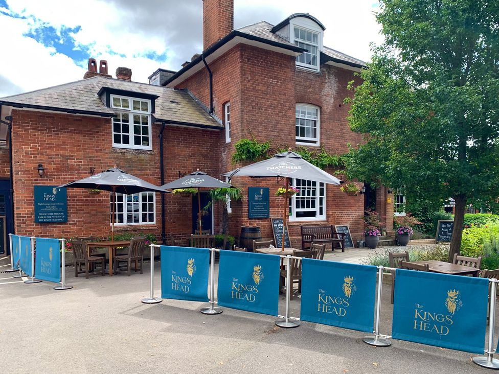 An exterior view of The King's Head pub with outdoor seating in Winchester