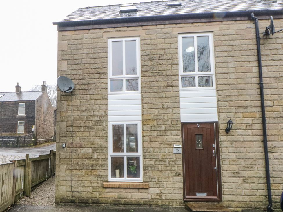 A building exterior with windows and door at 5 The Old Coach House Chinley