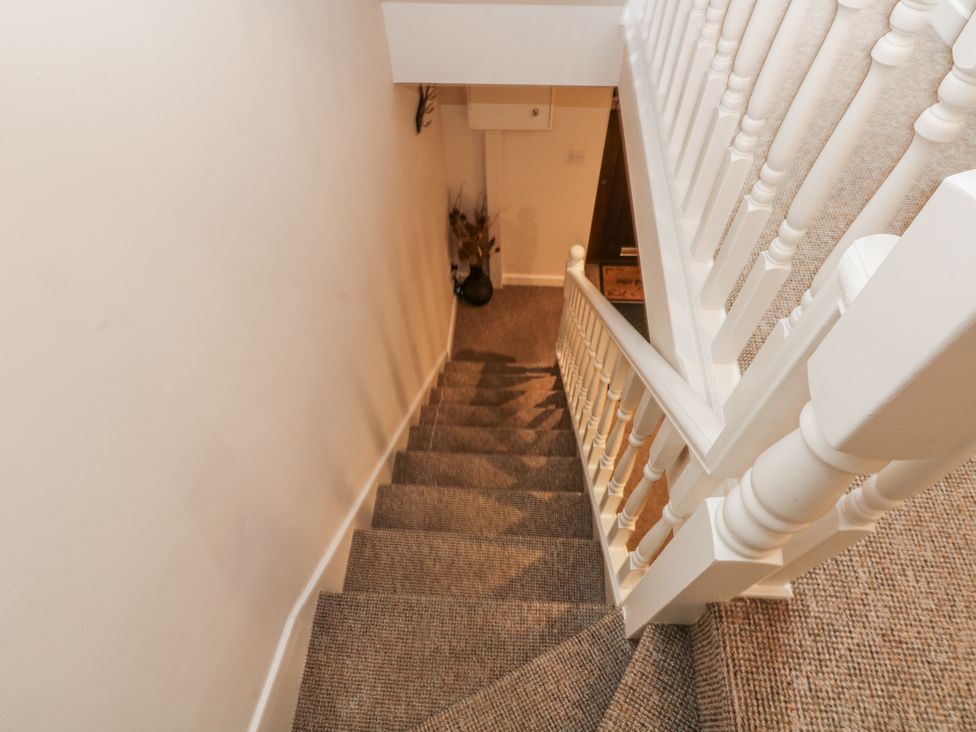 A staircase with a handrail and carpet at 5 The Old Coach House in Chinley