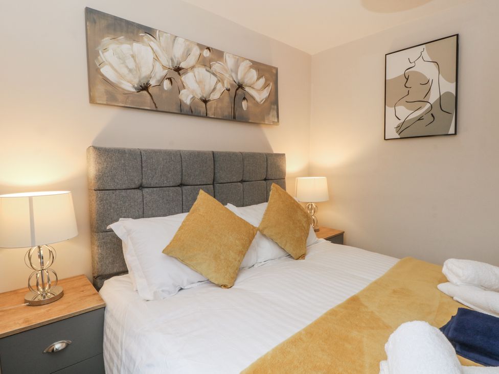 A bedroom with a bed and bedside tables at 5 The Old Coach House in Chinley
