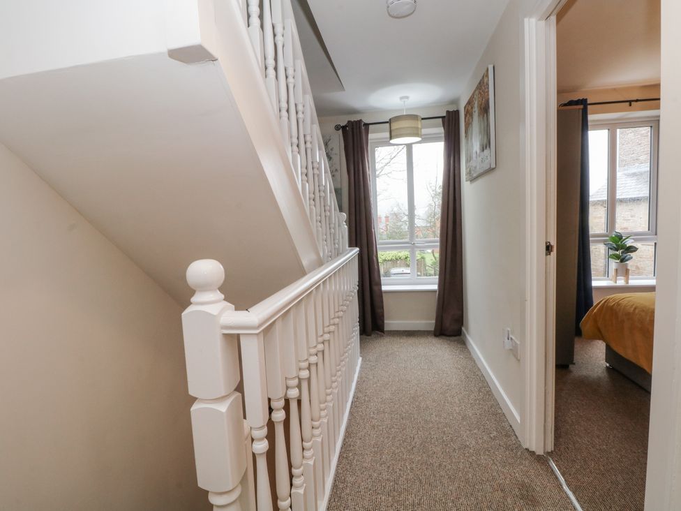 A hallway with stairs and window at 5 The Old Coach House Chinley