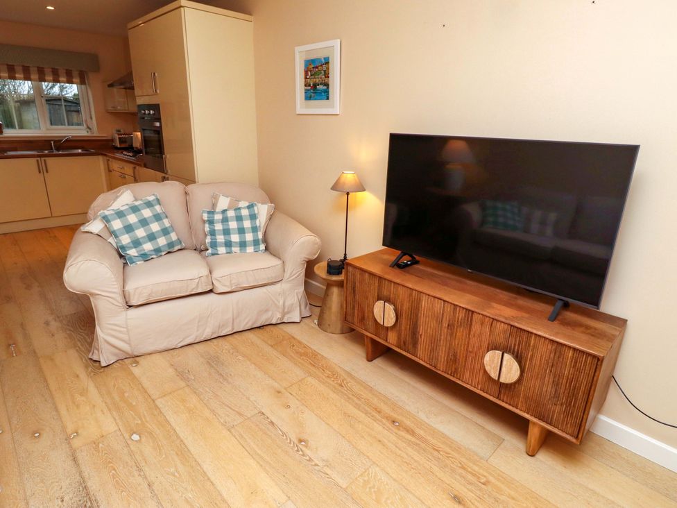 A living room with a sofa and television at High Sea View