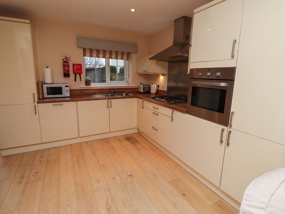 A kitchen with cabinets and appliances at High Sea View