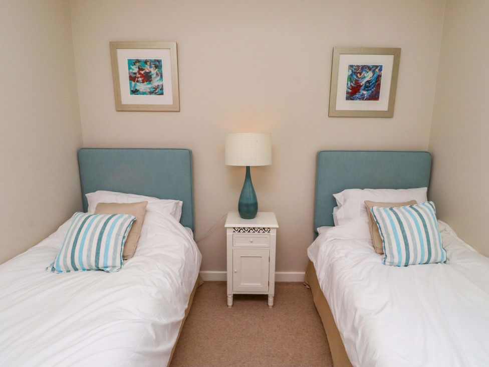 A bedroom with two beds and a lamp at High Sea View