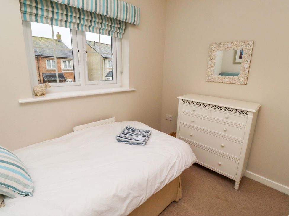 A bedroom with a bed and dressing table at High Sea View