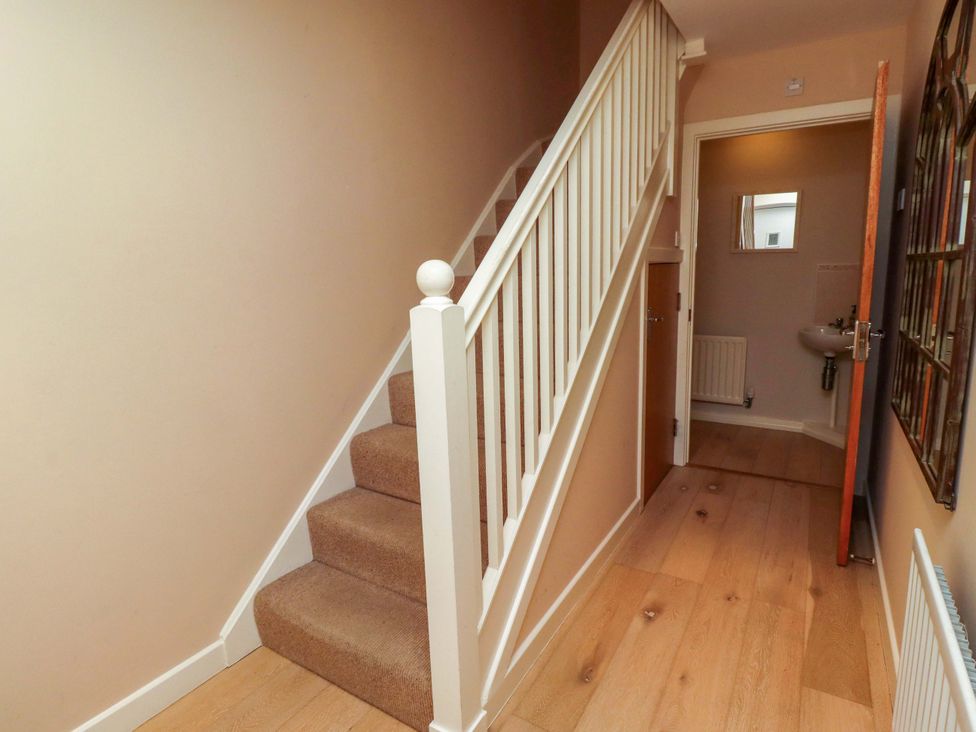A hallway with stairs leading to the upper floor at High Sea View 