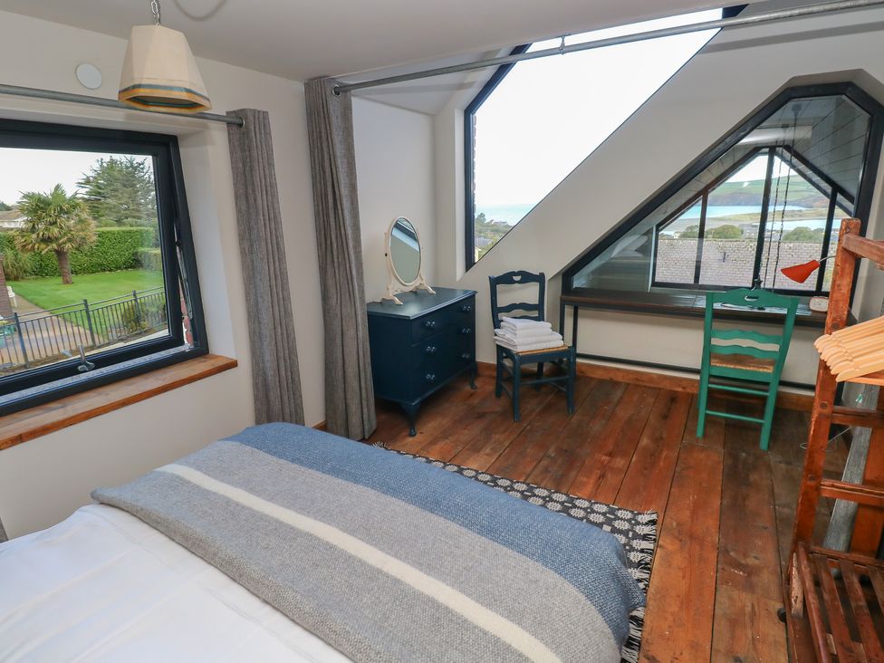 A bedroom with a bed and a window at The Barn in Newport
