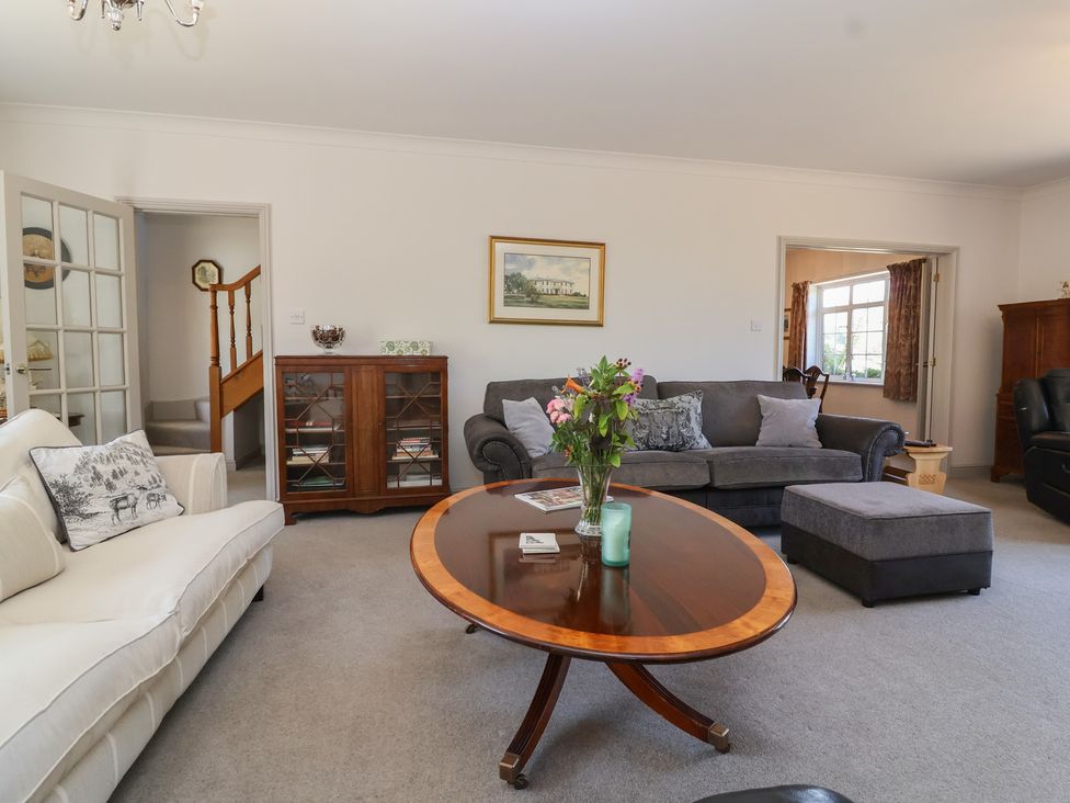 A living room with a sofa and coffee table at Leafield Cottage in Brockworth