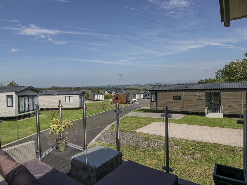 An outdoor area with holiday homes and a pathway at Grasmoor View Lodge in 