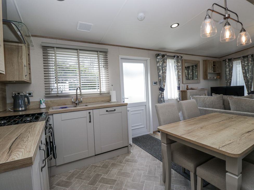 A kitchen with dining area and appliances at Grasmoor View Lodge