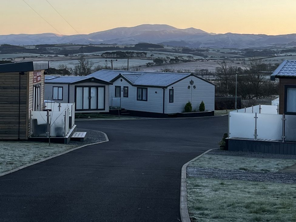 A view of mobile homes and a road with mountains in the background at Winscales Rest in Winscales
