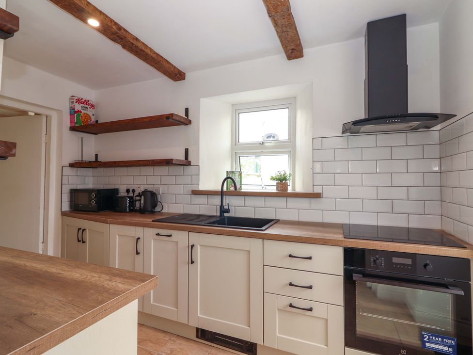A kitchen with a sink and countertop at The Farmhouse in Tralee, County Kerry