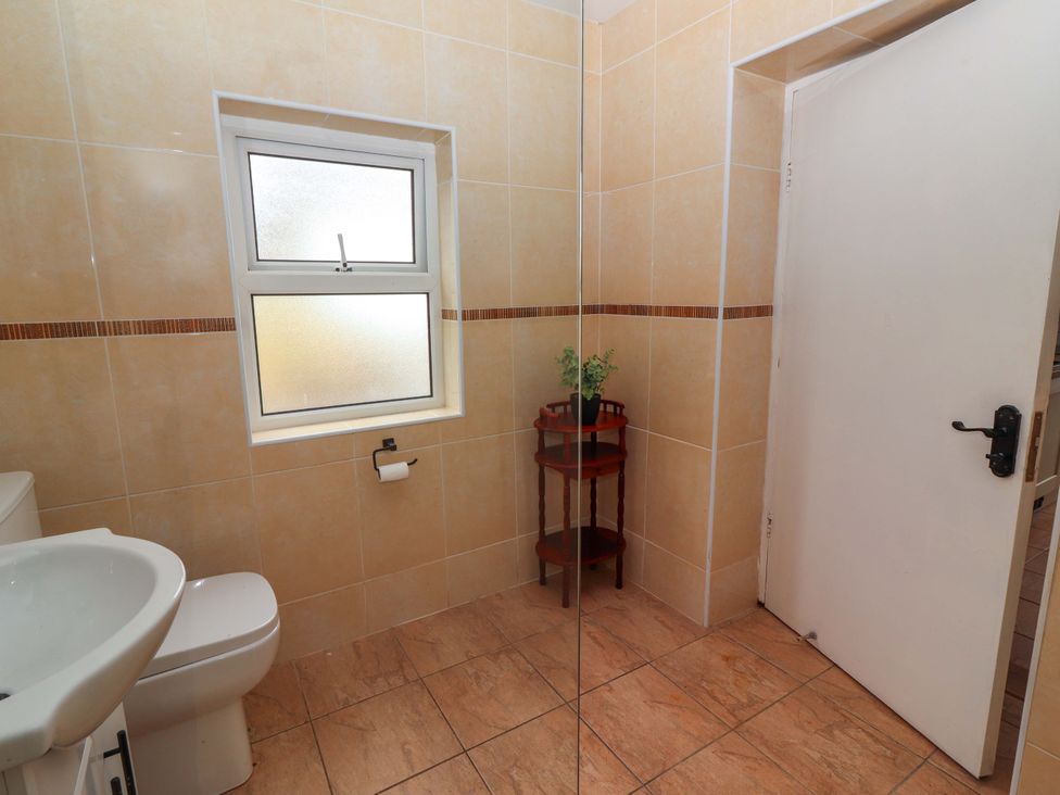 A bathroom with a sink and toilet at The Farmhouse in Tralee, County Kerry