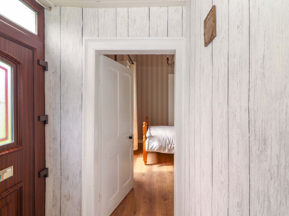 A hallway with a door leading to a bedroom at The Farmhouse in Tralee, County Kerry
