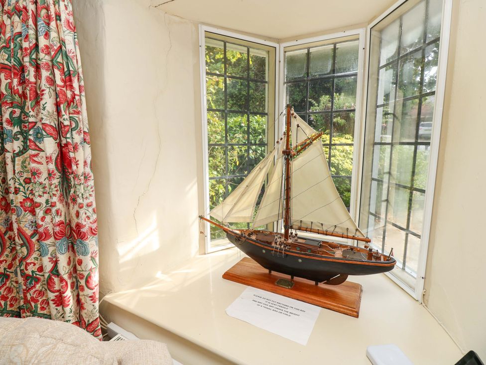 A model sailboat on a windowsill at Smugglers Cottage in New Milton