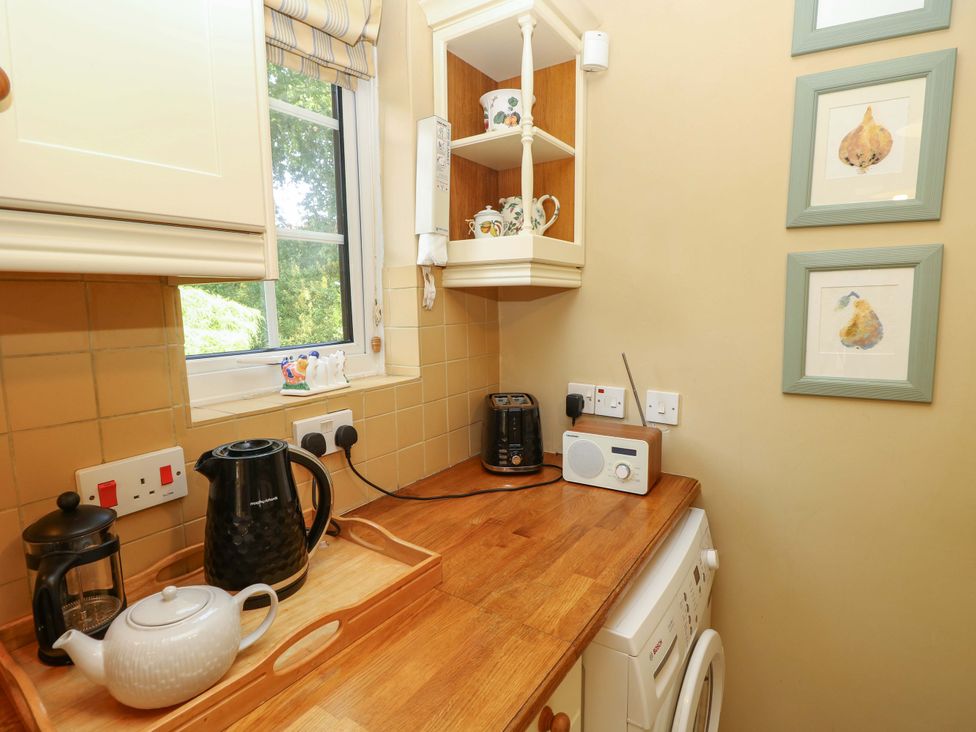 A kitchen with appliances and countertop at Smugglers Cottage in New Milton