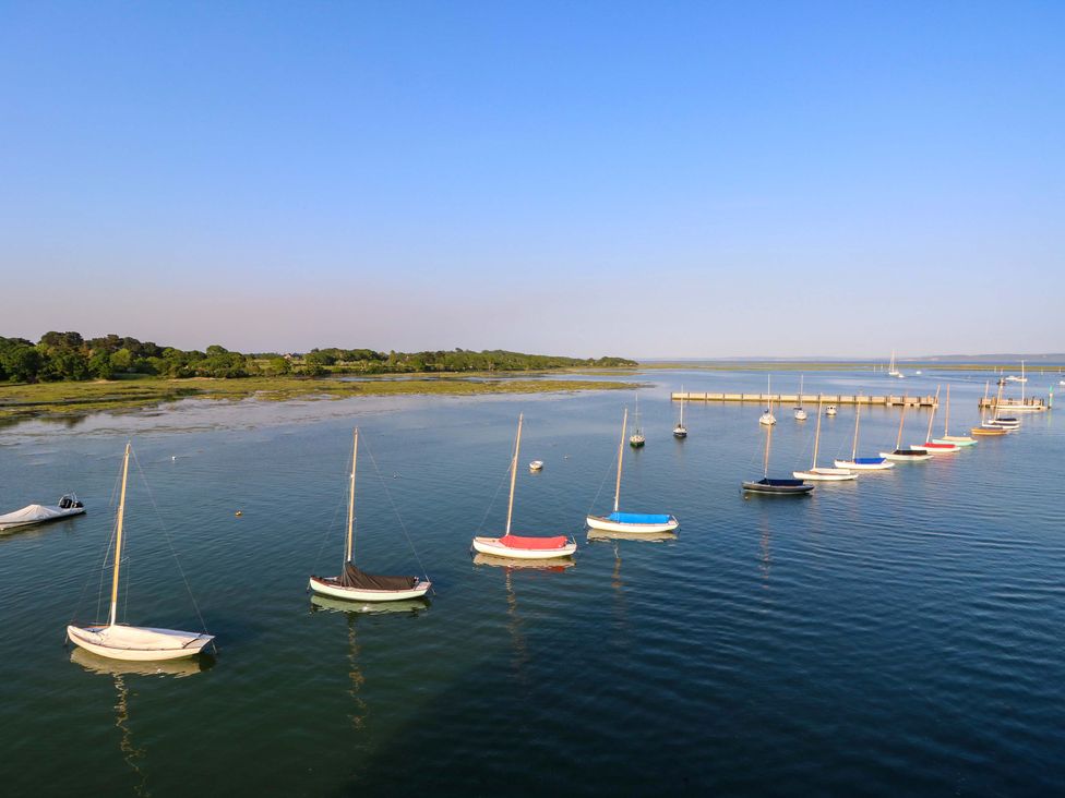 A marina with sailboats and a pier at Smugglers Cottage in New Milton