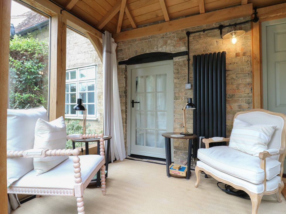 A snug with chairs and a side table at Little Barn @ Orwell