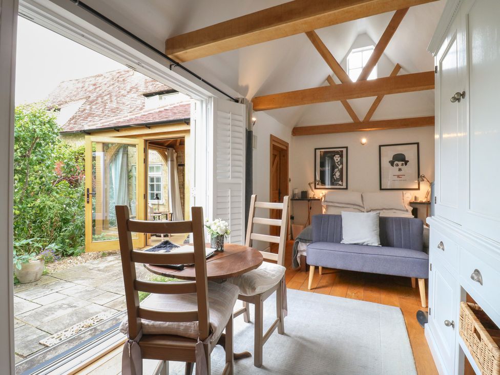 A sitting area with a table and chairs at Little Barn @ Orwell