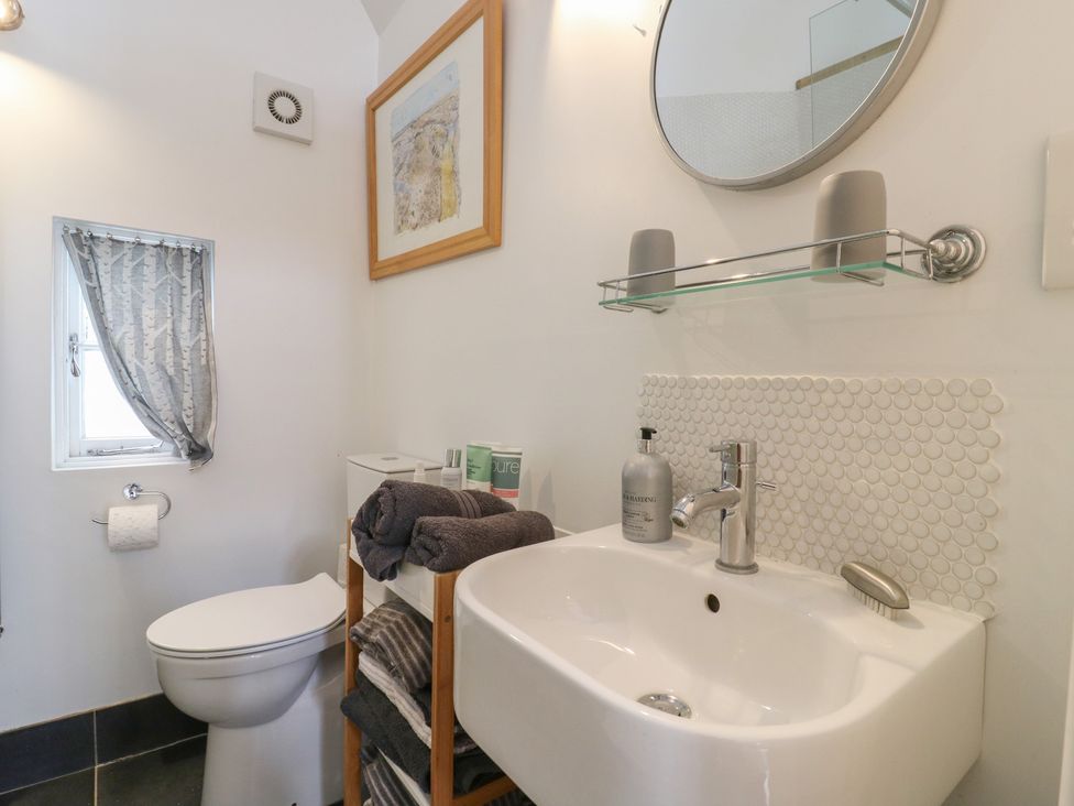 A bathroom with a sink and toilet at Little Barn @ Orwell