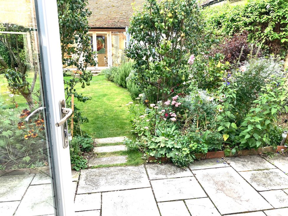 A garden with a path and flower bed at Little Barn in Orwell