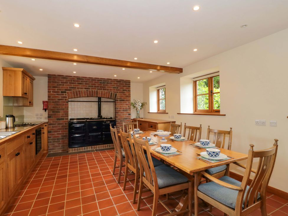 A kitchen with a dining table and chairs at Stowey Mead Stables in Bishop Sutton