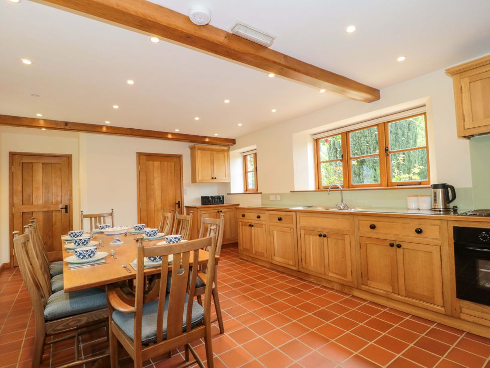 A kitchen with a dining table and chairs at Stowey Mead Stables Bishop Sutton