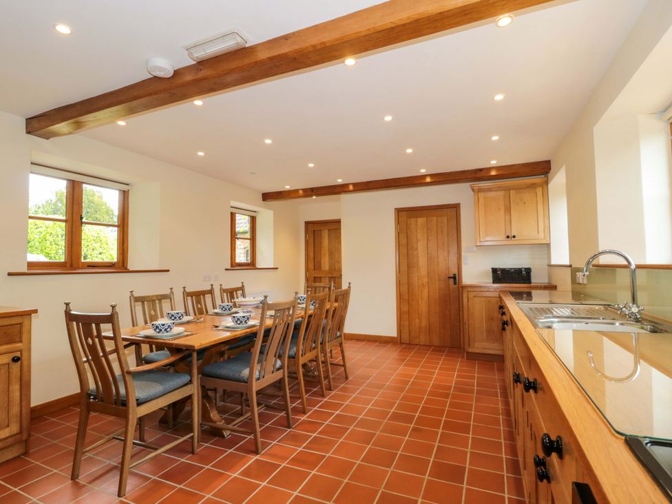A kitchen with a large table and chairs at Stowey Mead Stables in Bishop Sutton