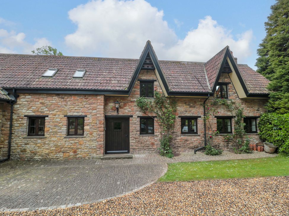A house with stone walls and a pathway at Stowey Mead Stables Bishop Sutton