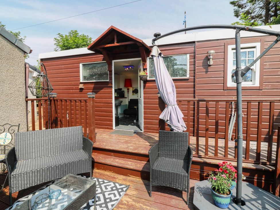 An outdoor deck area with seating and access to a cabin at The Cabin in East Wemyss near Buckhaven