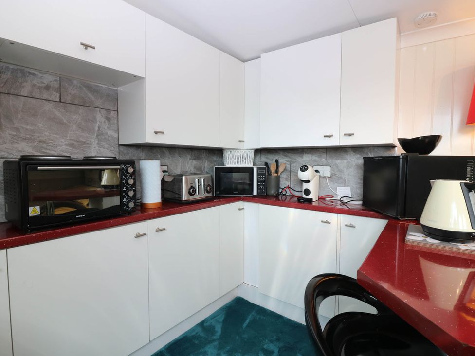 A kitchen with appliances including a microwave and coffee machine at The Cabin in East Wemyss near Buckhaven