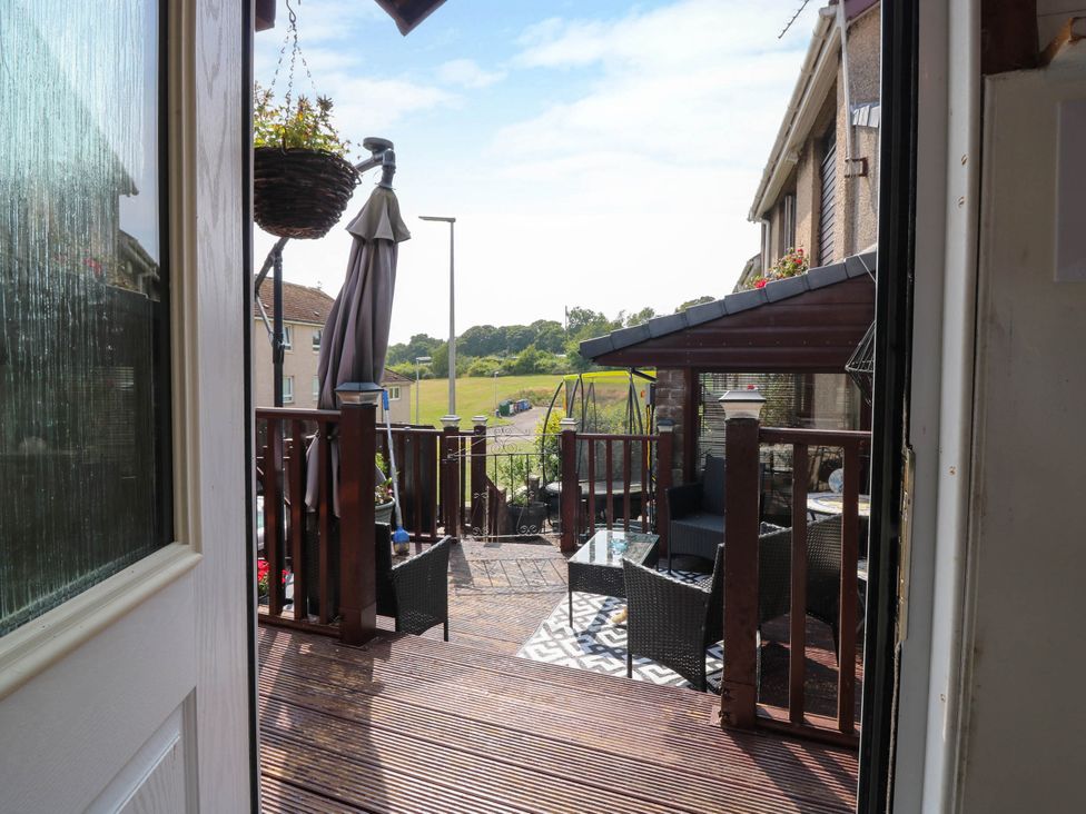 A deck with outdoor furniture and a view of a grassy area at The Cabin in East Wemyss near Buckhaven