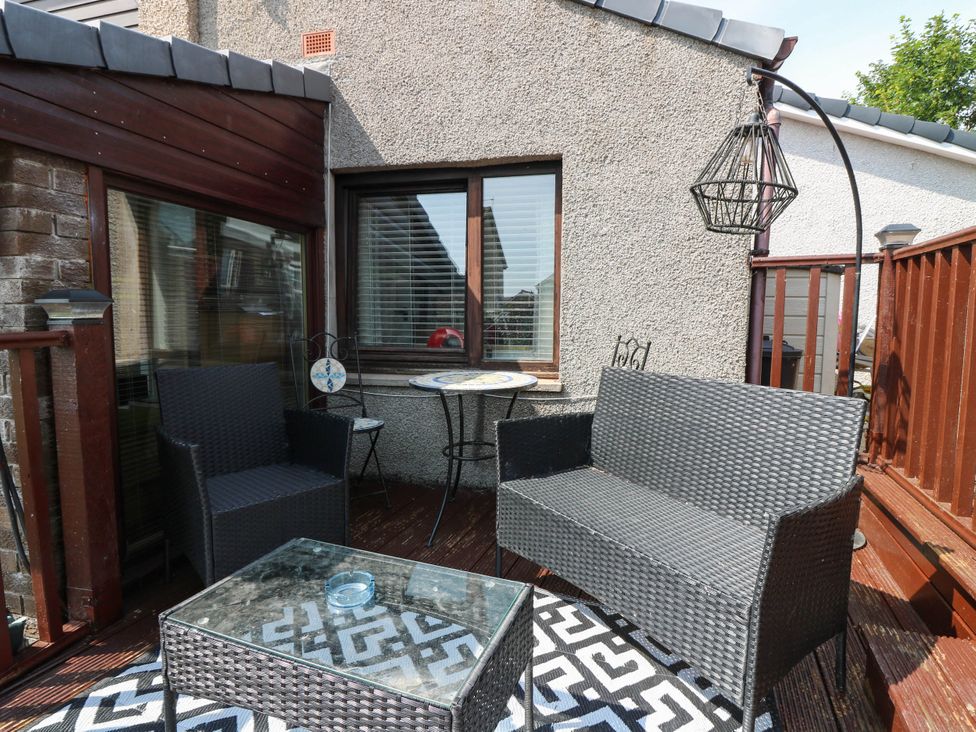 An outdoor seating area with a sofa, armchair and table at The Cabin in East Wemyss near Buckhaven