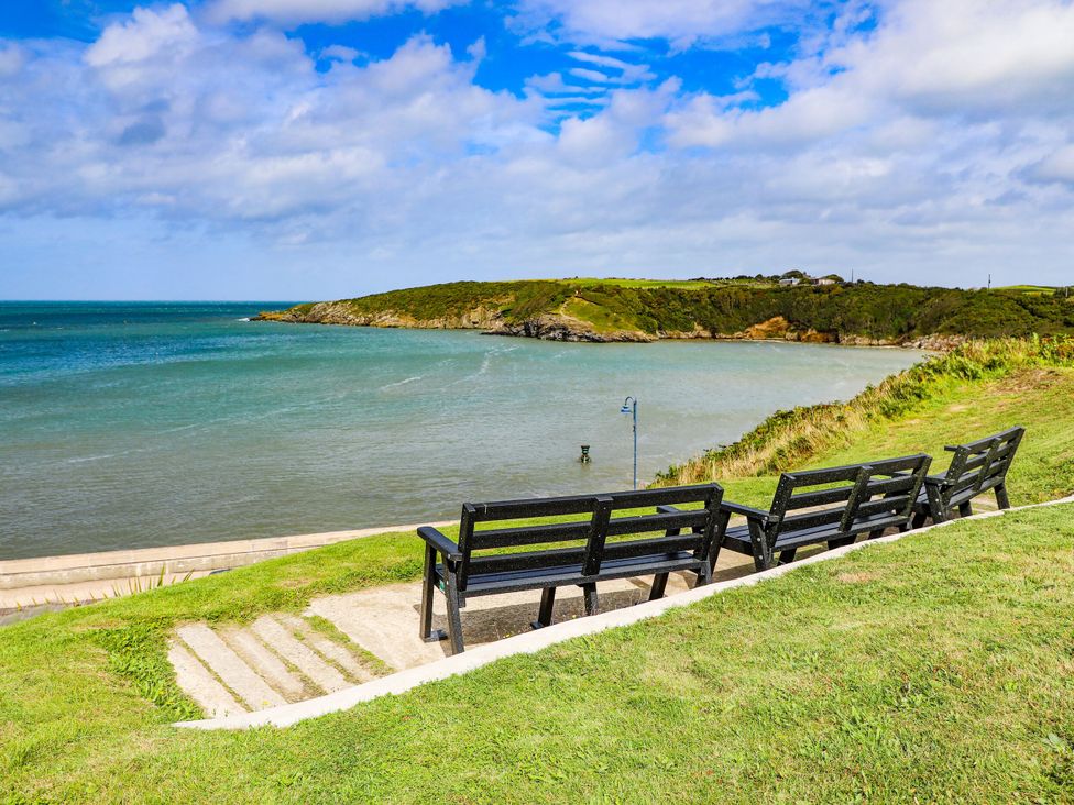 A view of benches overlooking the water at 2 Harbour Lights Cemaes Bay